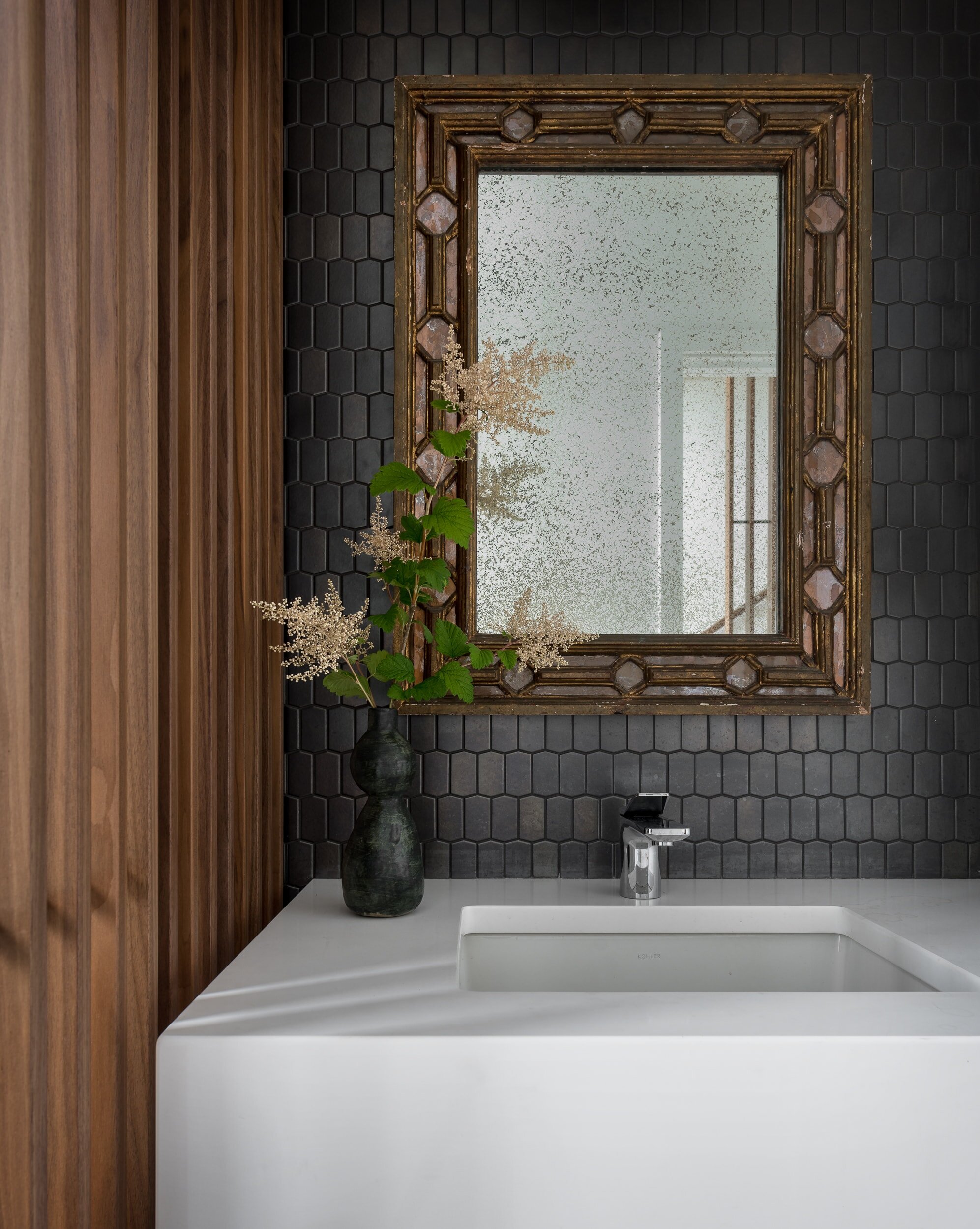 designer bathroom tile backsplash with artistic mirror