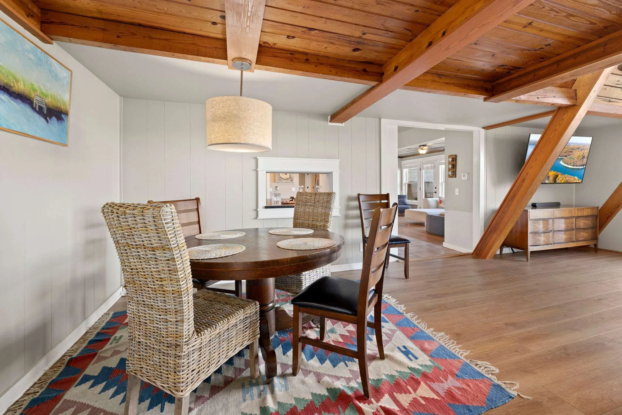 Just to the right of the kitchen is our second great room with a dining table and seating.