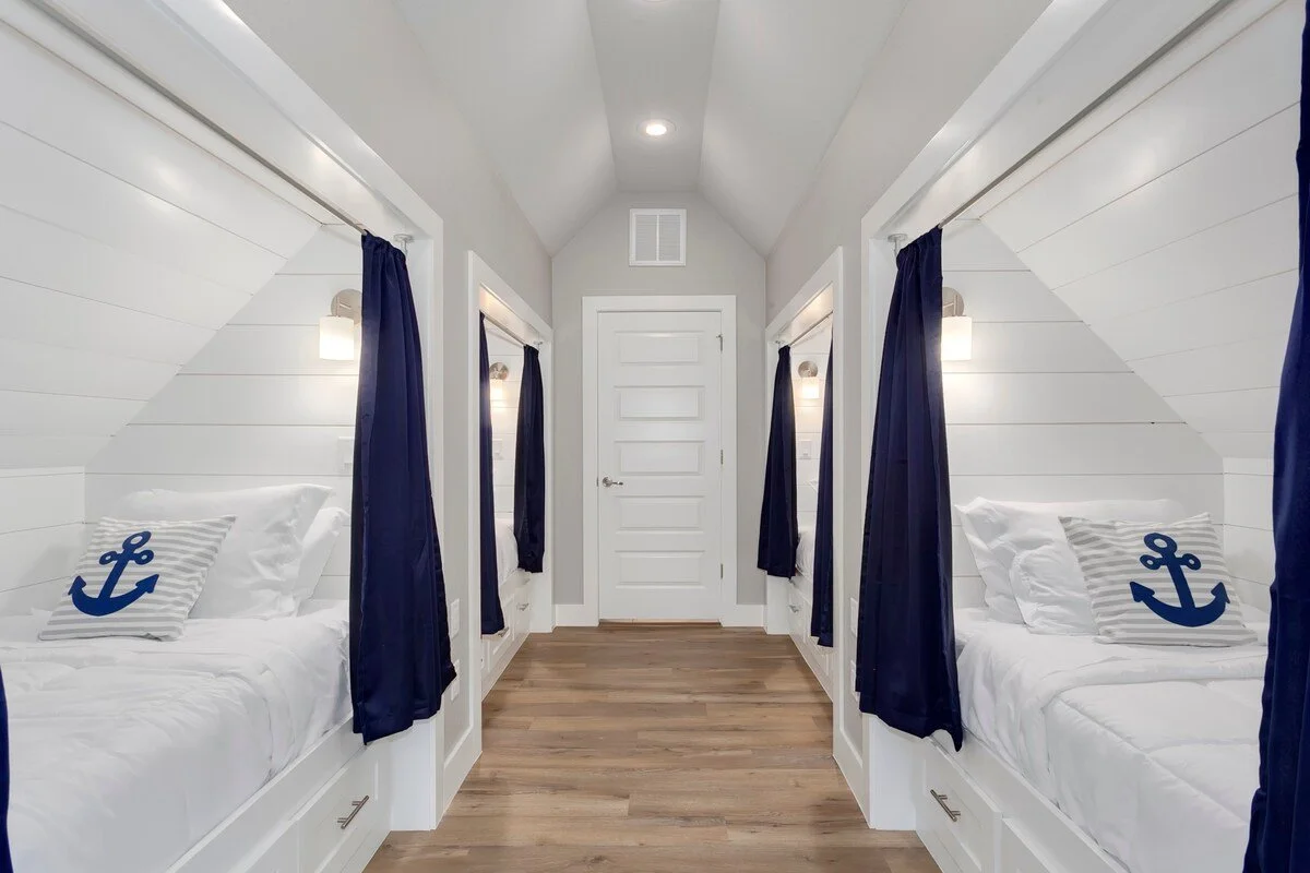 Tucked into their own private nooks much like beds on a luxury ship, each of the twin beds has its own curtains for privacy. Past the Twin beds is a spacious bathroom with a shower.
