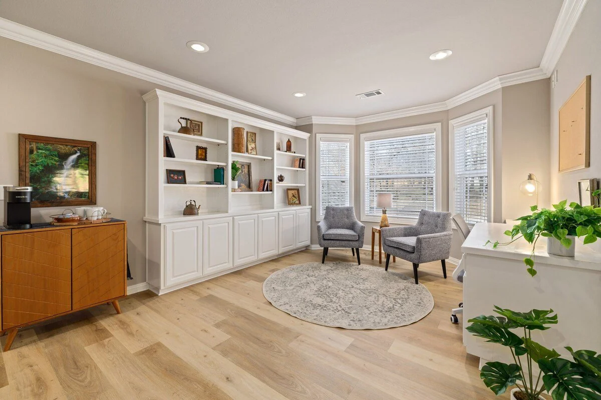 A study room, complete with a coffee bar, bookshelf, 2 seats (great for reading!), and desk area. 