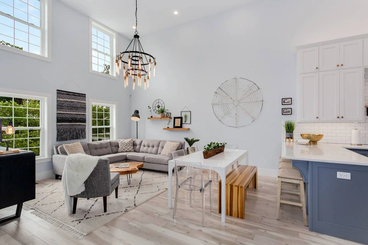 A combined living room and kitchen area featuring an extra-long kitchen table, perfect for accommodating all guests during dining.