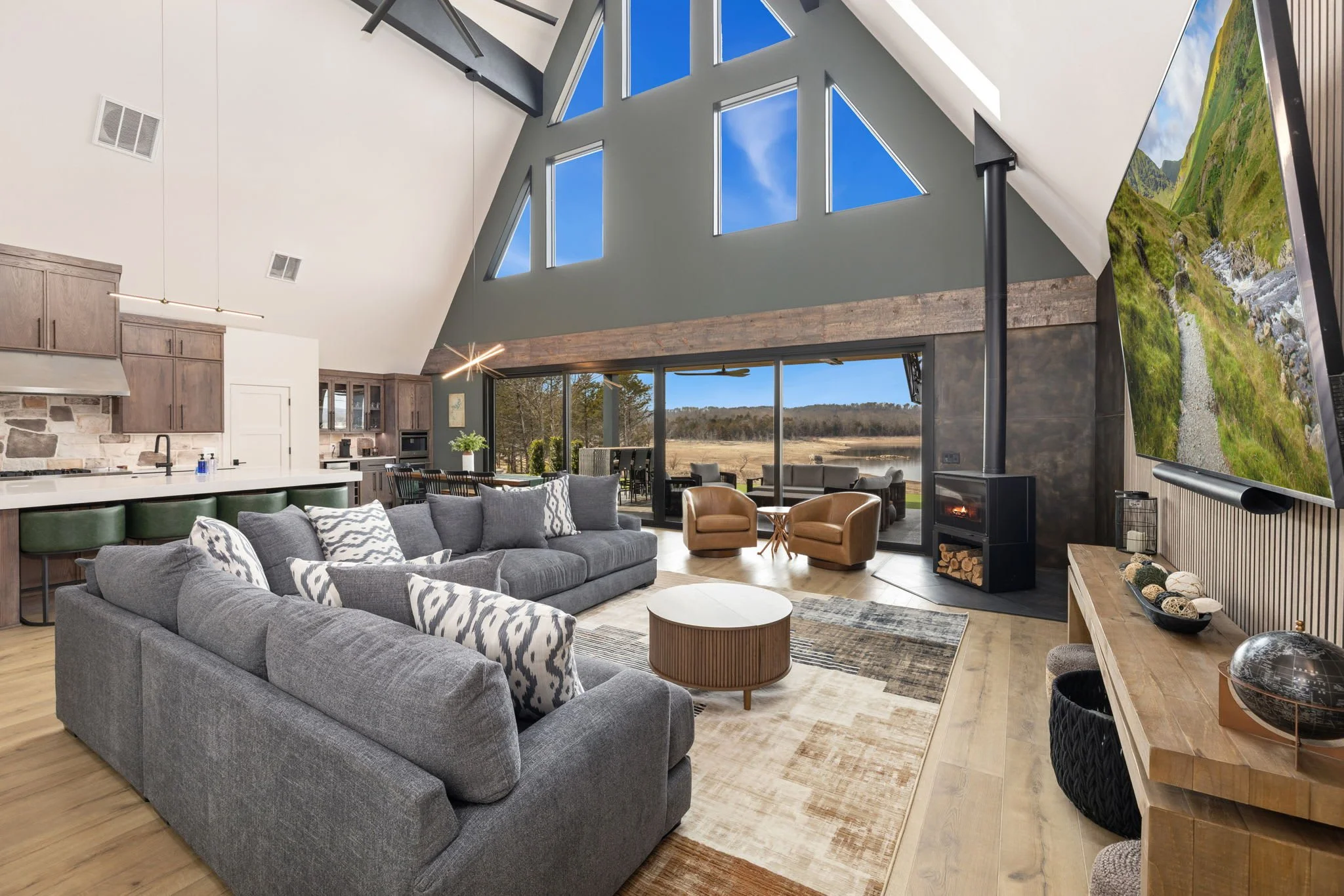 Inside, you'll love the open concept living space and kitchen area in the center of the A-frame. This entire space is flooded with natural light and boasts gorgeous views of Beaver Lake. 
