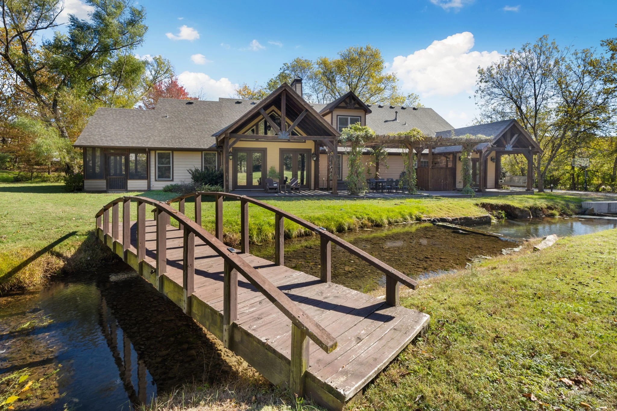 Peaceful stream with a bridge that runs through the back yard!