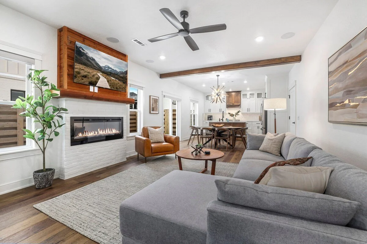 When you enter our home, you'll immediately enter into our open concept living room. This has to be our favorite spot in the house with its natural wood finishes, cozy seating, gas fireplace, and access to our fenced in patio. 