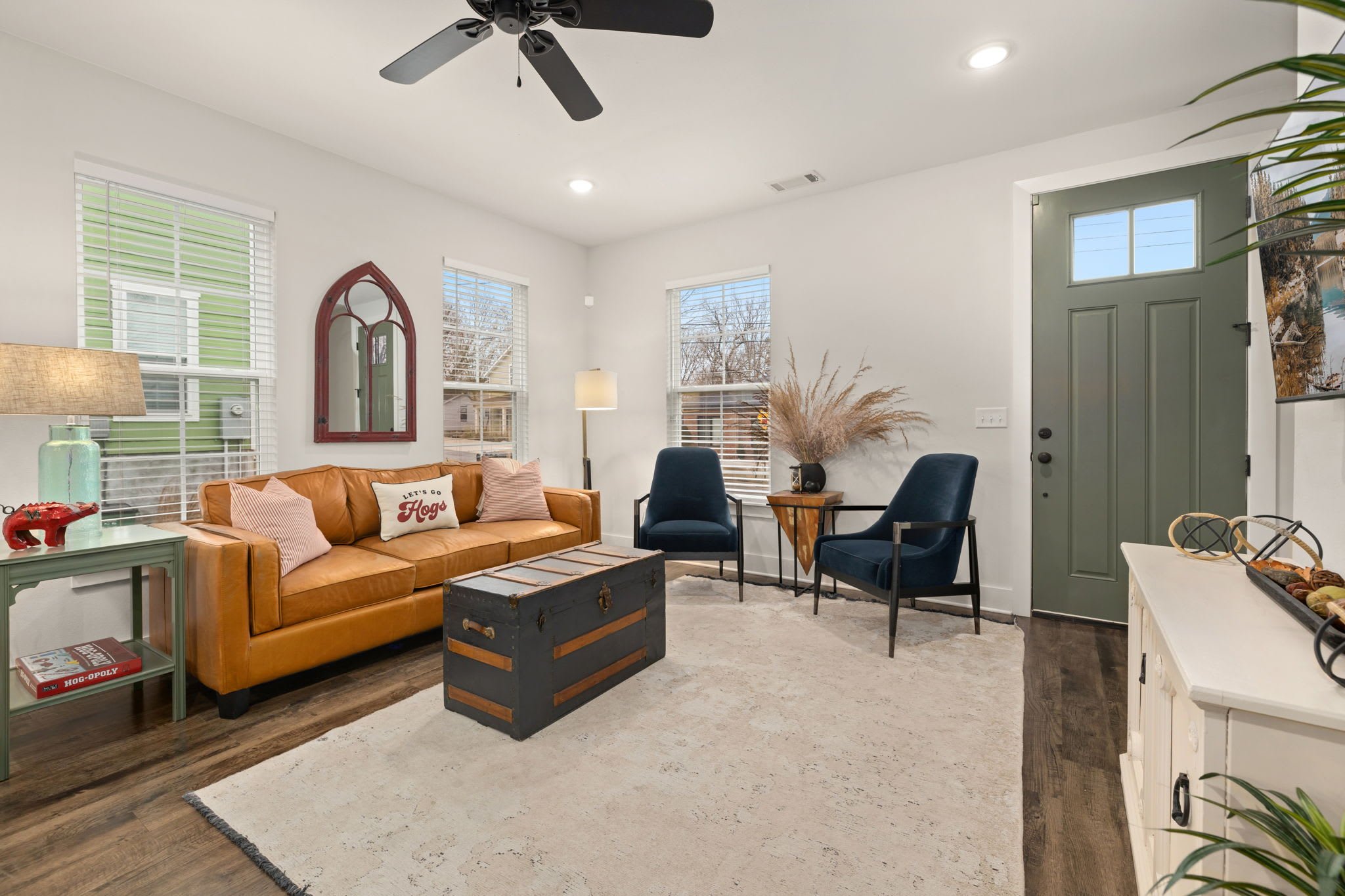The living room features cozy seating and a Smart TV.