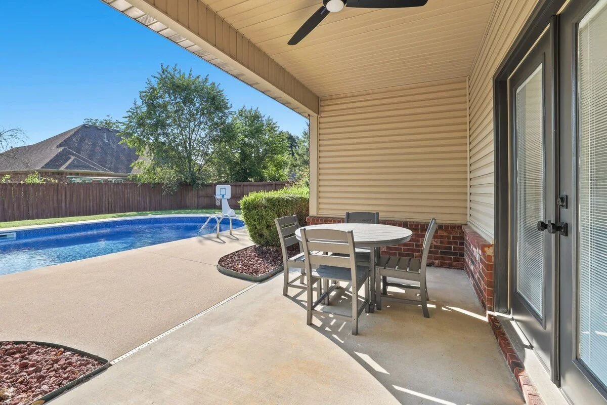 From the kitchen/dining area, you'll also have access to the covered patio, pool and back yard. We invite you to unwind on our outdoor patio, with a four-top dining table.