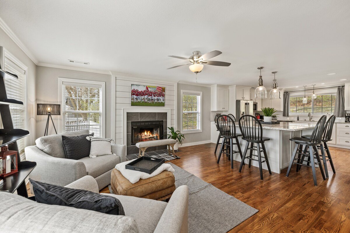 Want to watch two programs at once? Our secondary living space, just off of the kitchen, features cozy conversation seating, another large smart TV and a fireplace. 