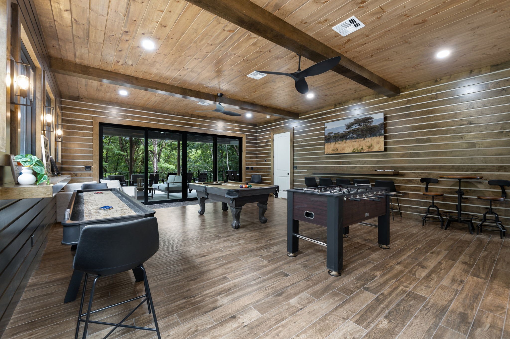 The gameroom's patio access emphasizes Roaring River Hideaway's indoor-outdoor lifestyle.