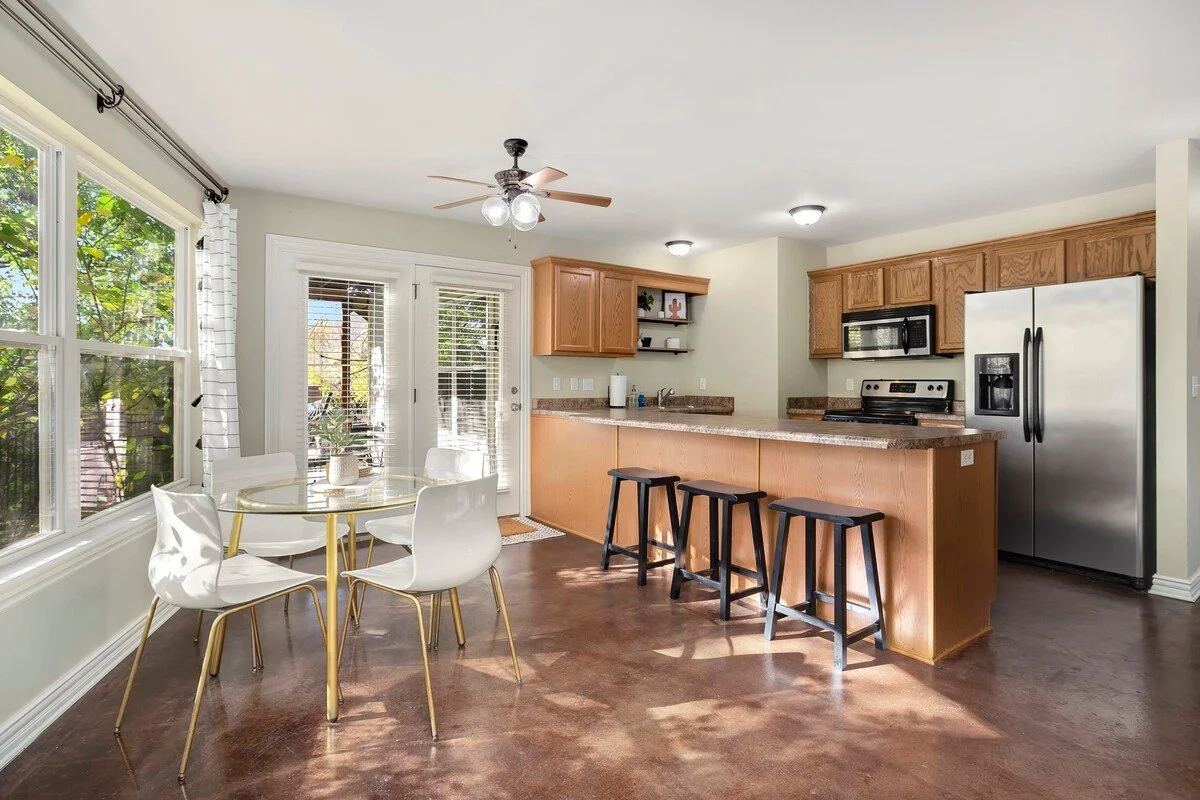 This kitchen features high-end amenities and appliances, a large bar with seating for 3 and direct access to the backyard. 