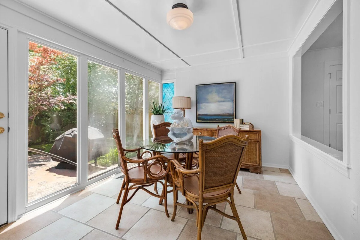This space is complete with two swivel chairs, a four-top dining table, a Samsung Smart TV, board games, floor-to-ceiling windows and a door leading to the backyard. 
