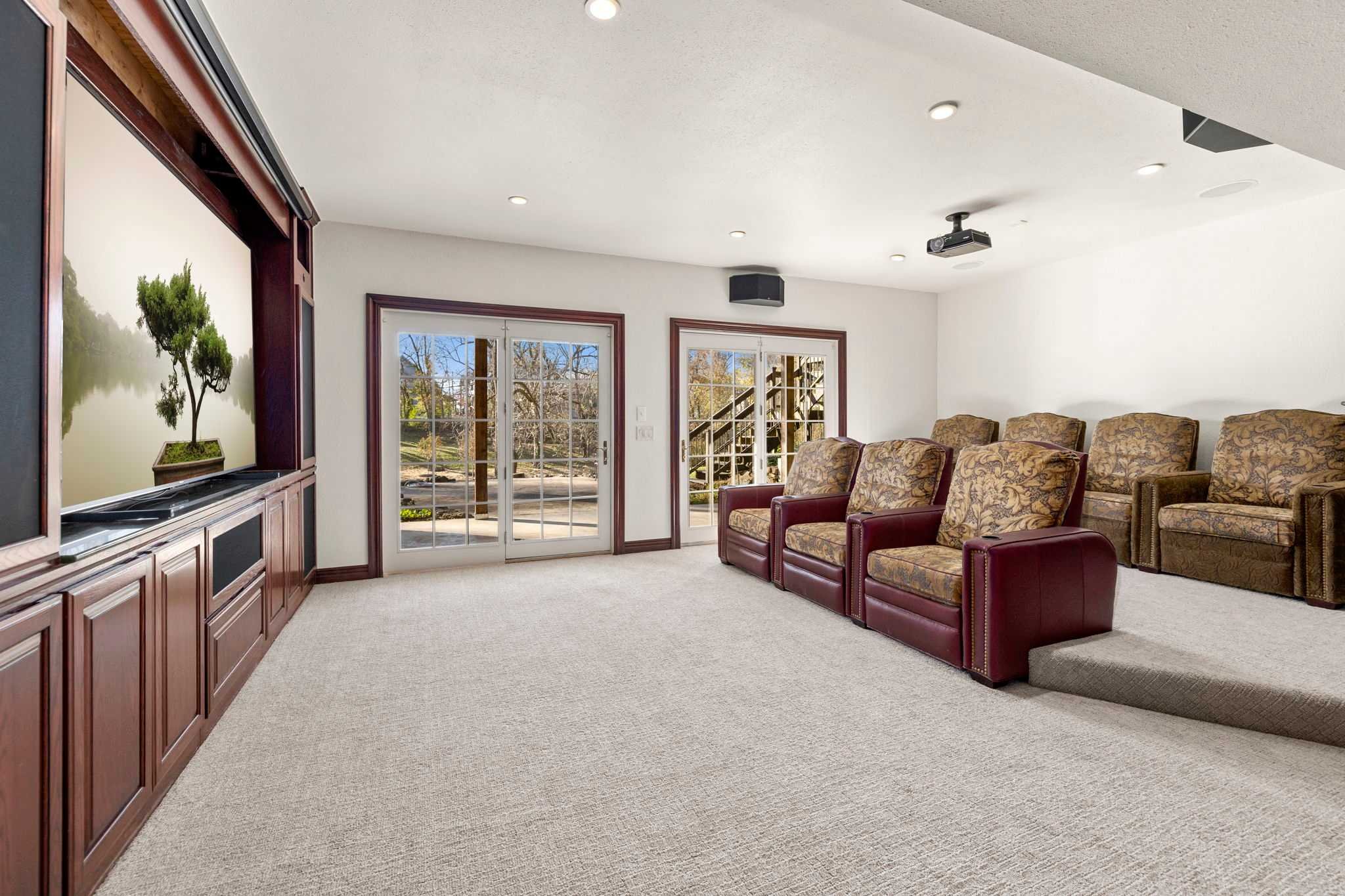 Downstairs is our home theater! With 7 lounge chairs and a massive TV screen, a projector, streaming apps, and a sound system, this is the perfect spot to watch all your favorites!