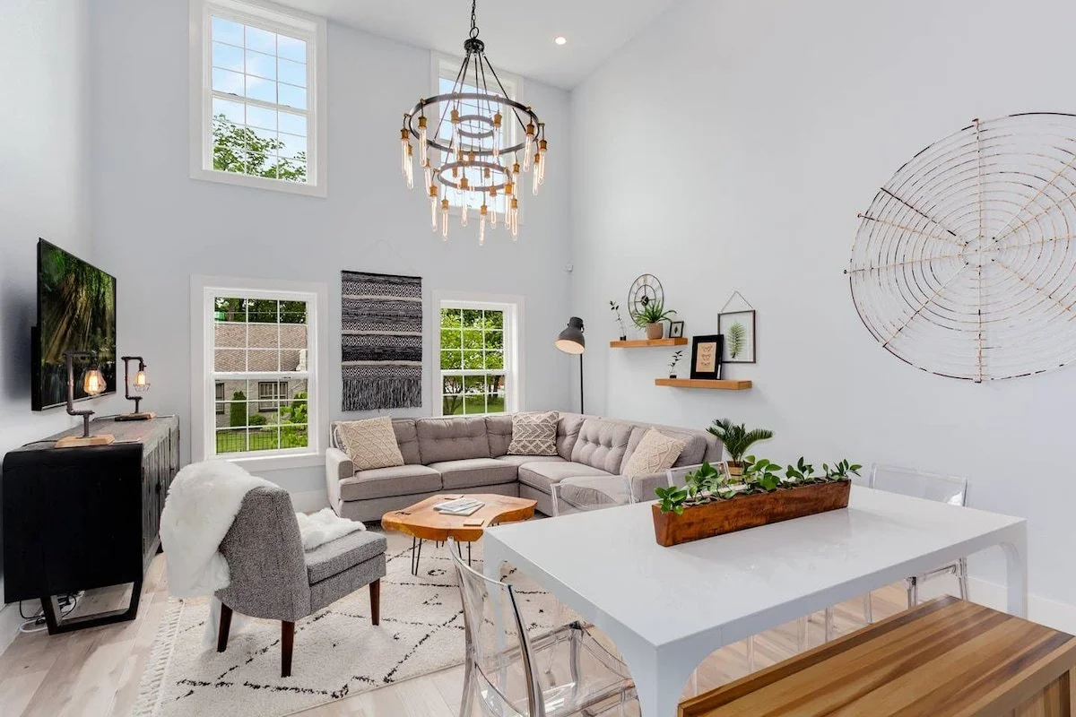 The large windows let in an abundance of natural light, which fills the tastefully decorated space with both modern and traditional elements.