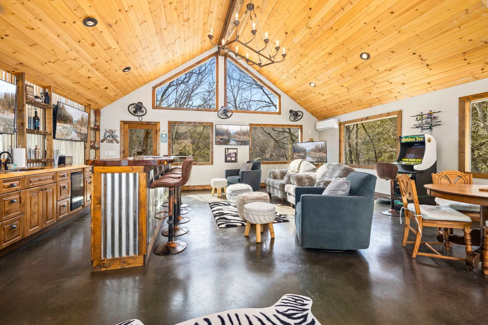 For additional recreation, head to the game room, complete with a wet bar, FOUR Smart TVs, a Golden Tee game console, and a Wii.