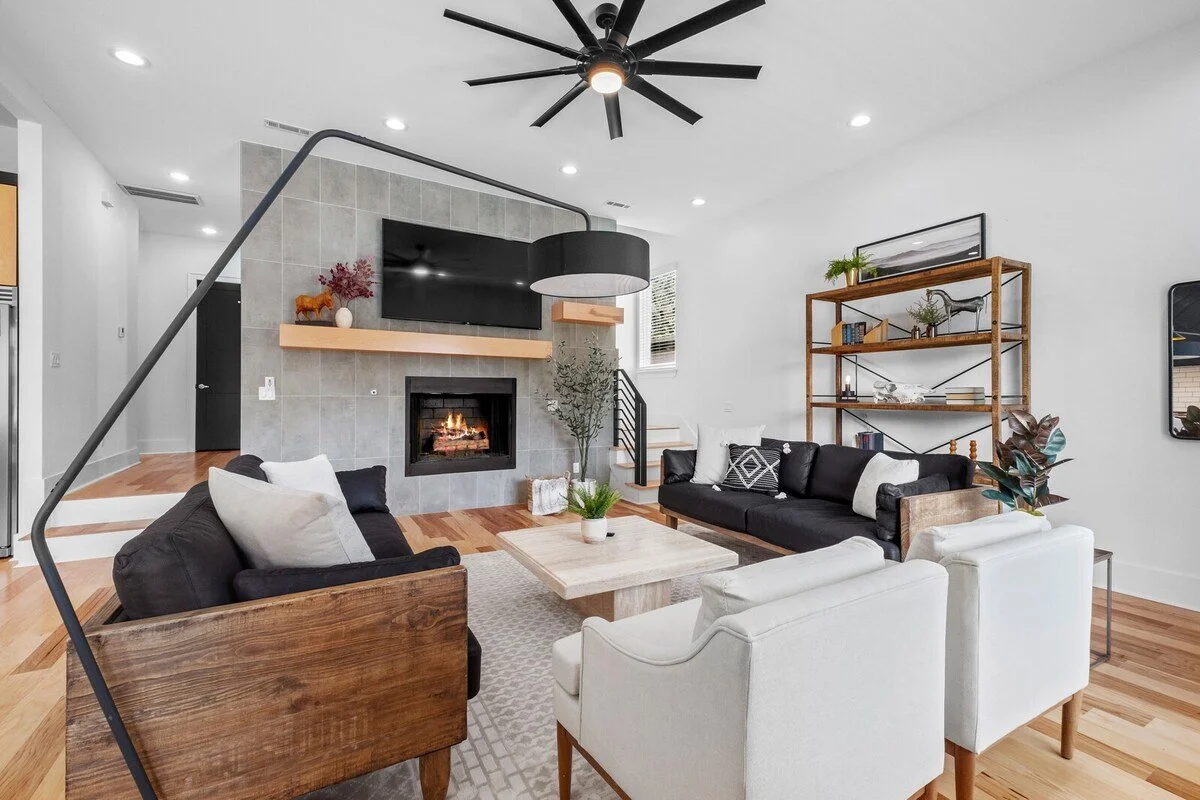 Relax in our spacious, open-concept living room - complete with ample seating, large windows, a 75-inch Smart TV and gorgeous gas fireplace.