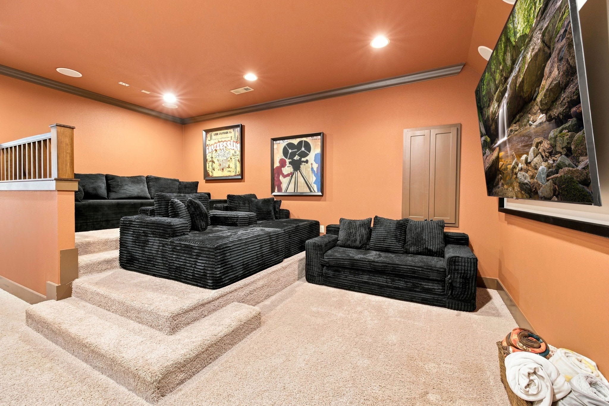Upstairs is our Movie theatre room! Enjoy another living space, HUGE Smart TV, and raised couches for a real movie theatre experience.