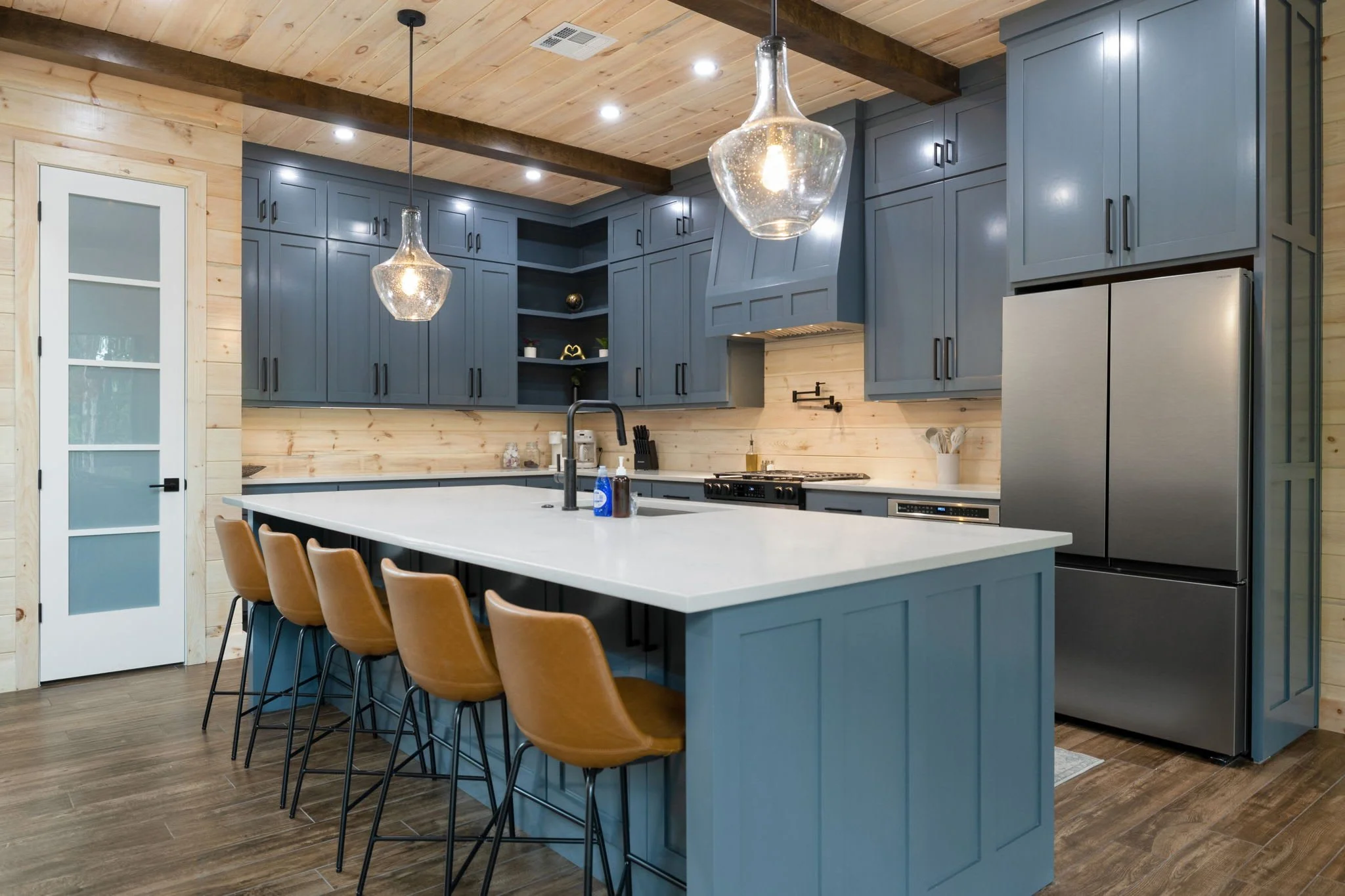 The kitchen is fully stocked with everything you'll need, including new appliances and island seating for 5.