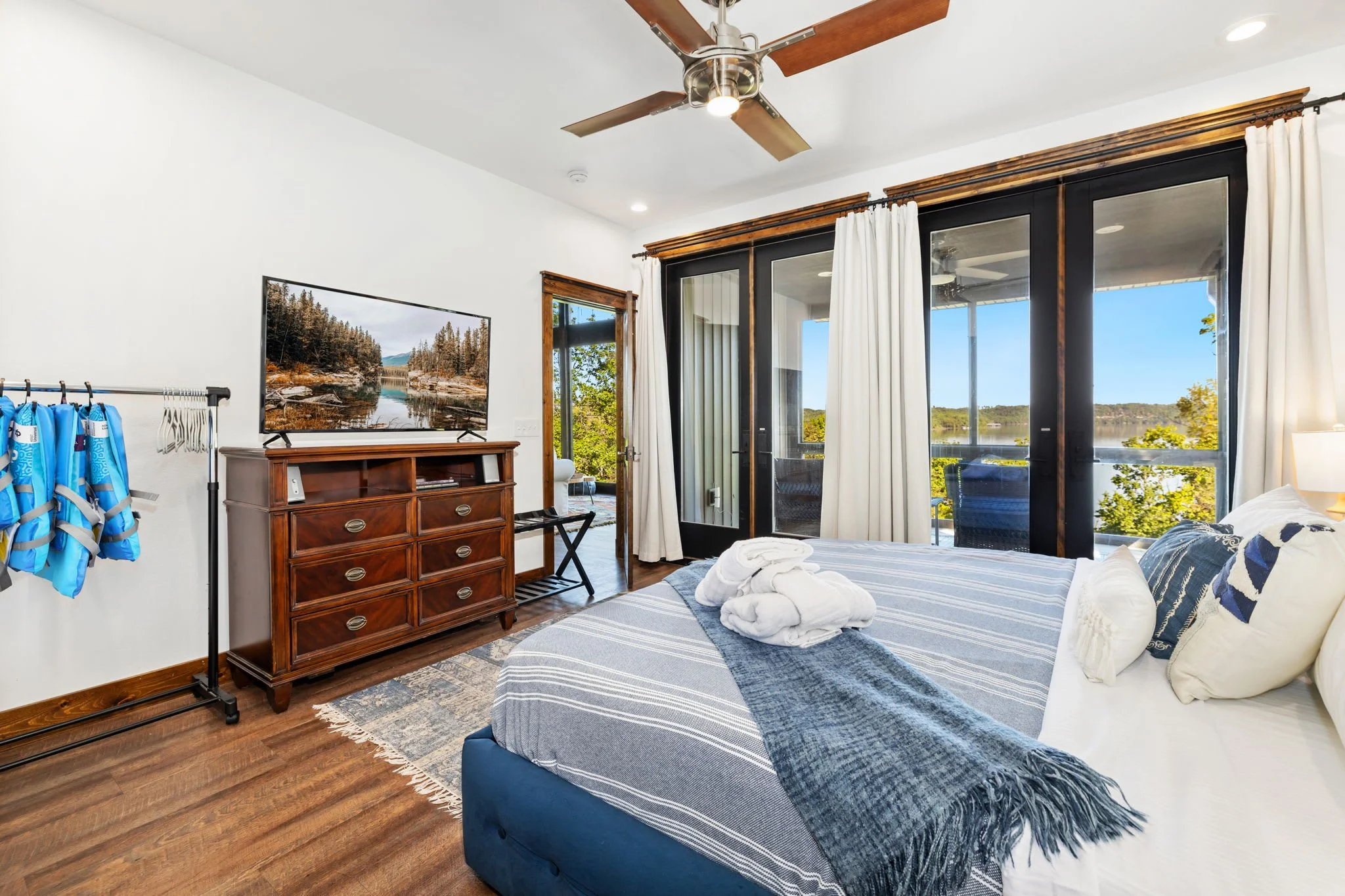 To the right of the living room is the primary bedroom, which enjoys its own private screened-in patio. — In total, there are four bedrooms, accommodating 10 guests.