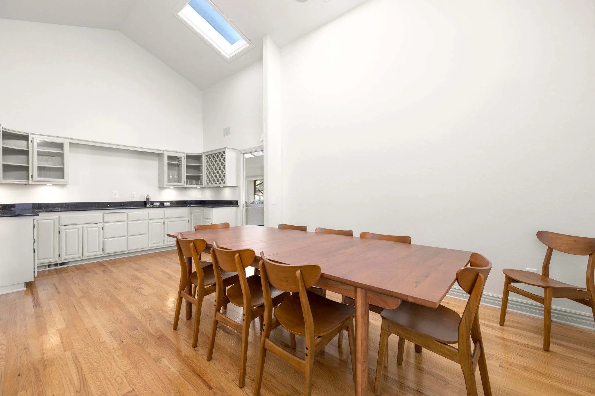 The formal dining space has a large table for 8 and a wet bar with wine cabinet.