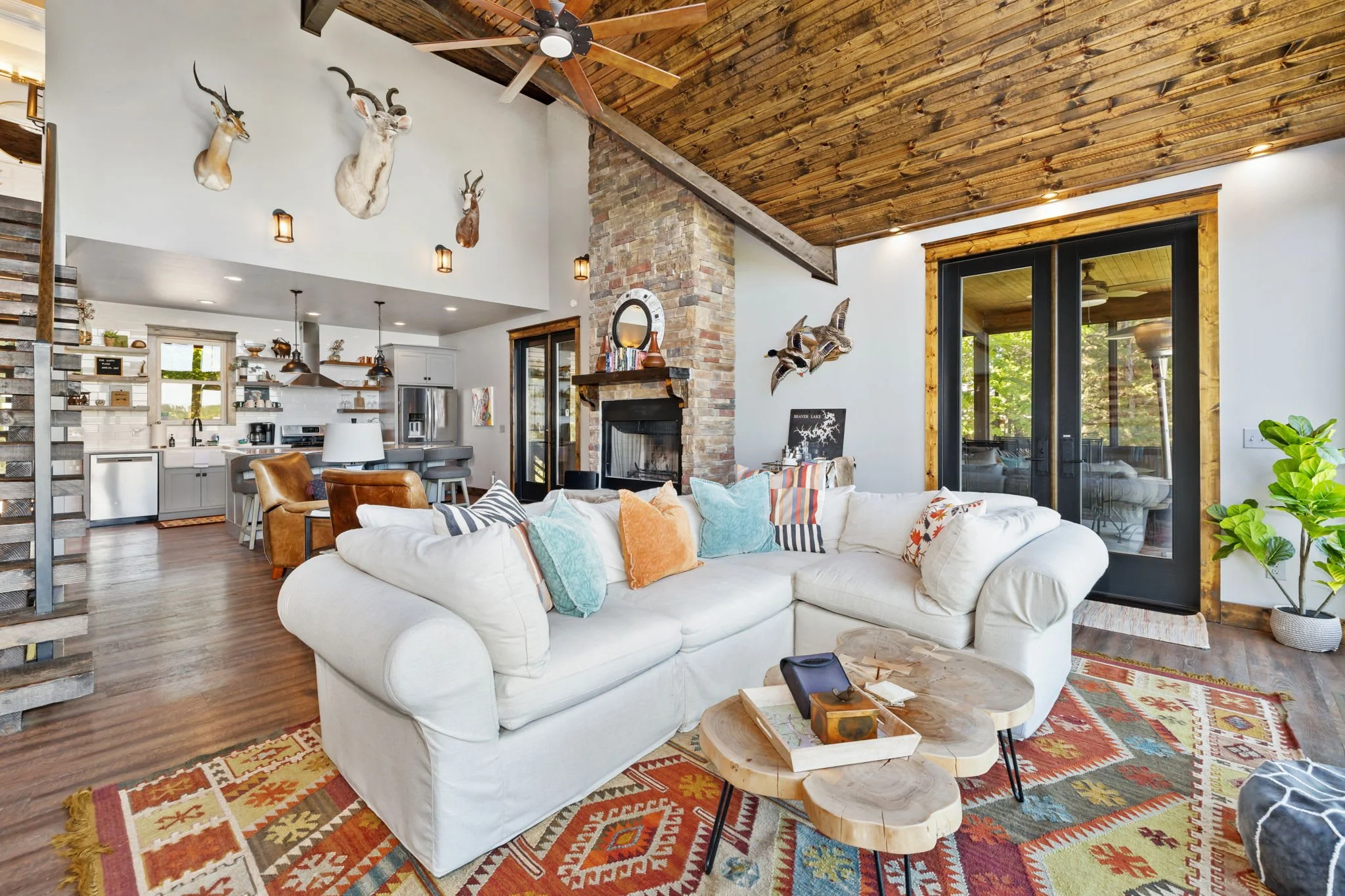 The living room has seating, a fireplace, and books, and access to the screened in patio.