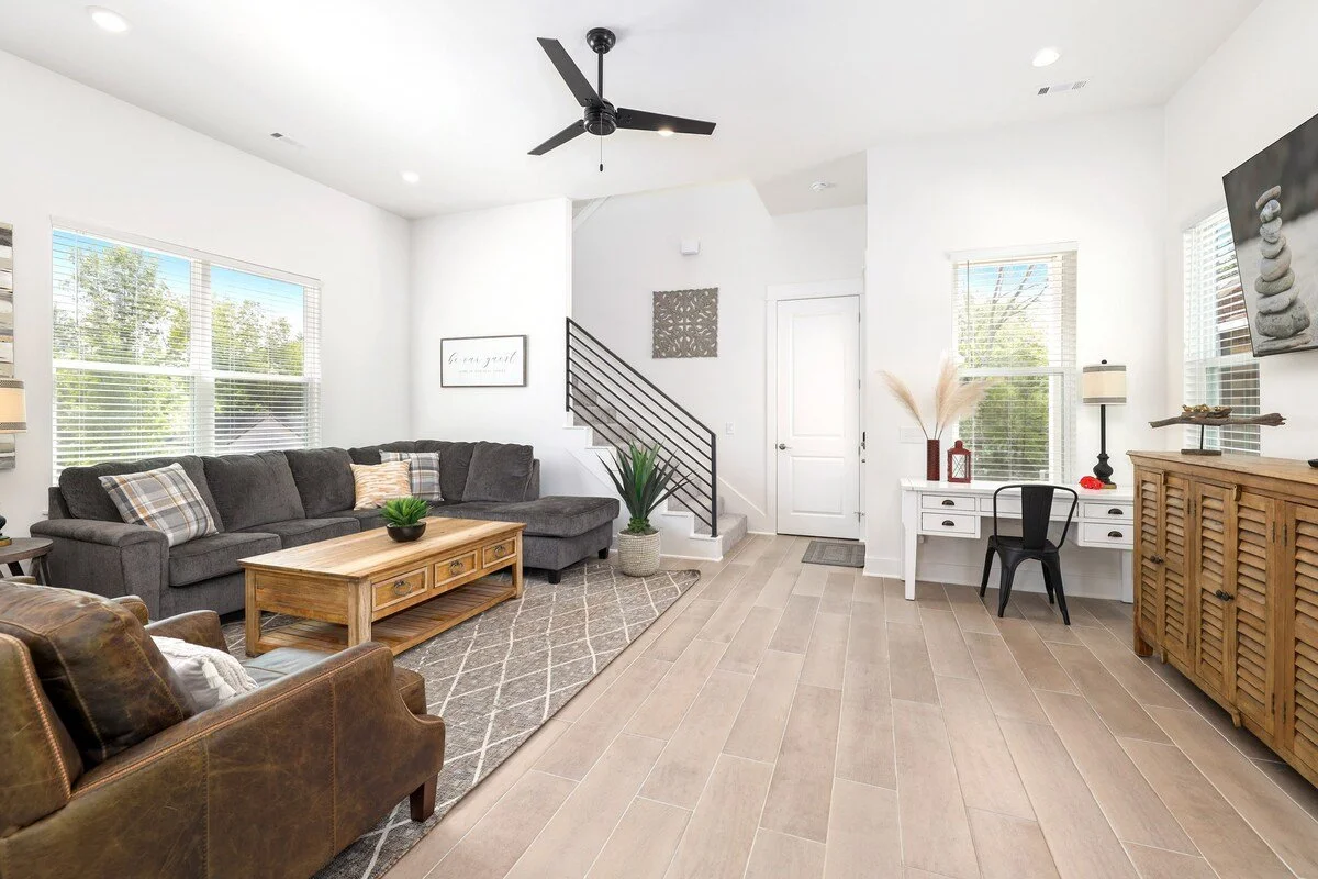 Upon entering our home, turn to the left and enter our open concept living area. Our main lounge area is complete with a huge sectional, two plush leather lounge chairs and a desk.