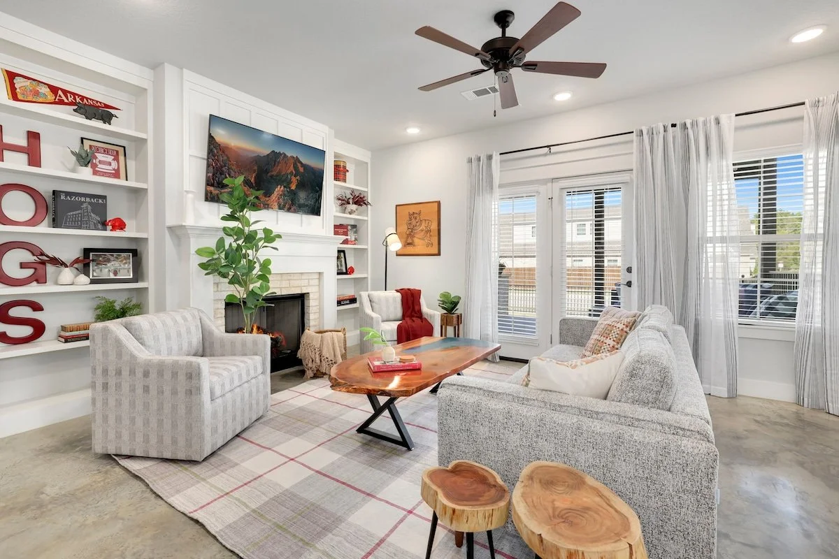 Our living room has a cozy gray couch, two overstuffed lounge chairs, a 60-inch Samsung Smart TV with cable, gas fireplace and tons of Hog-centric flair. Next to the TV, you'll also find Pictionary and Checkers. This space is our favorite place to wa