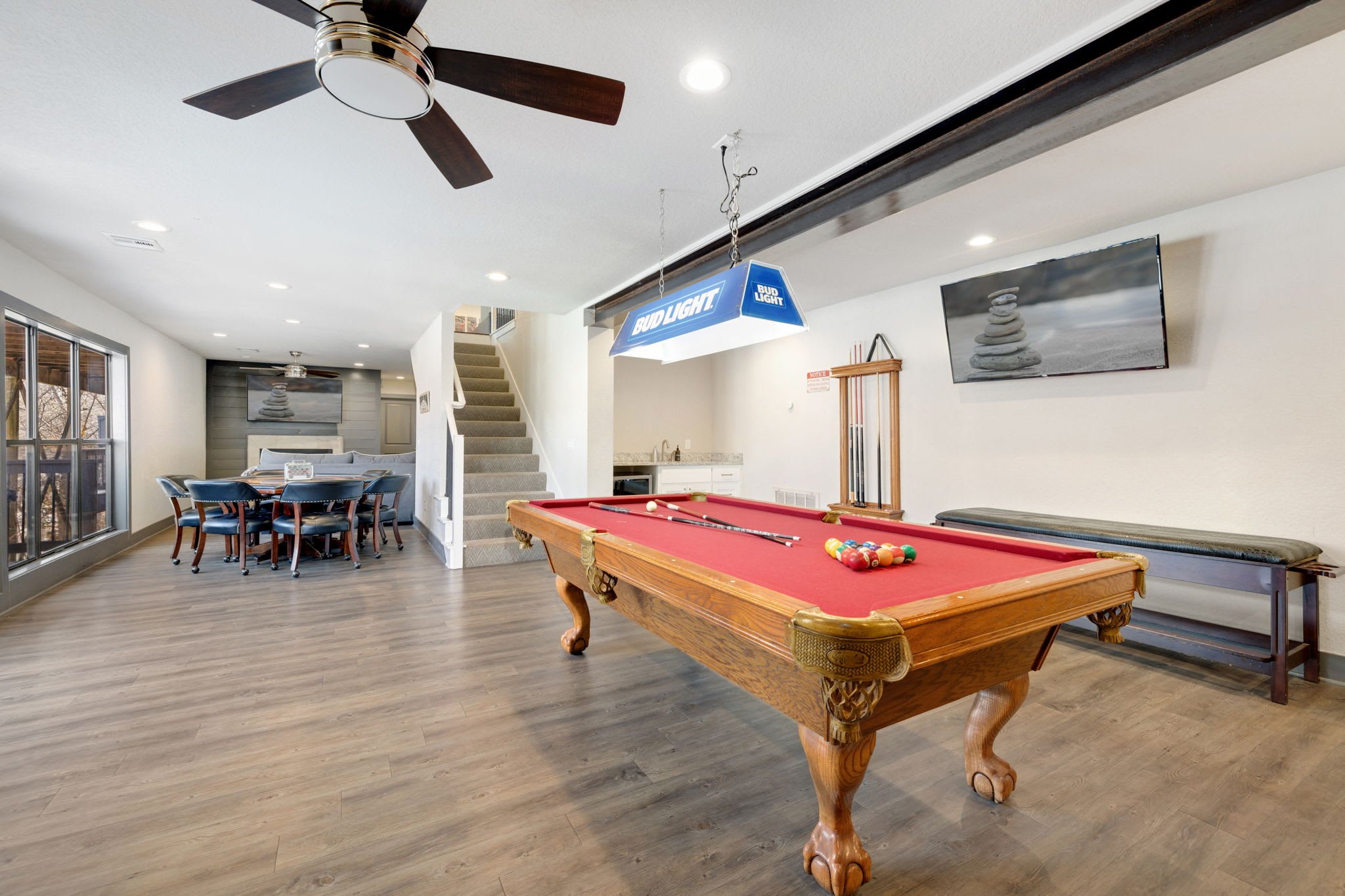 This huge space has more seating, a wet bar, a pool table, poker table, board games and a ....