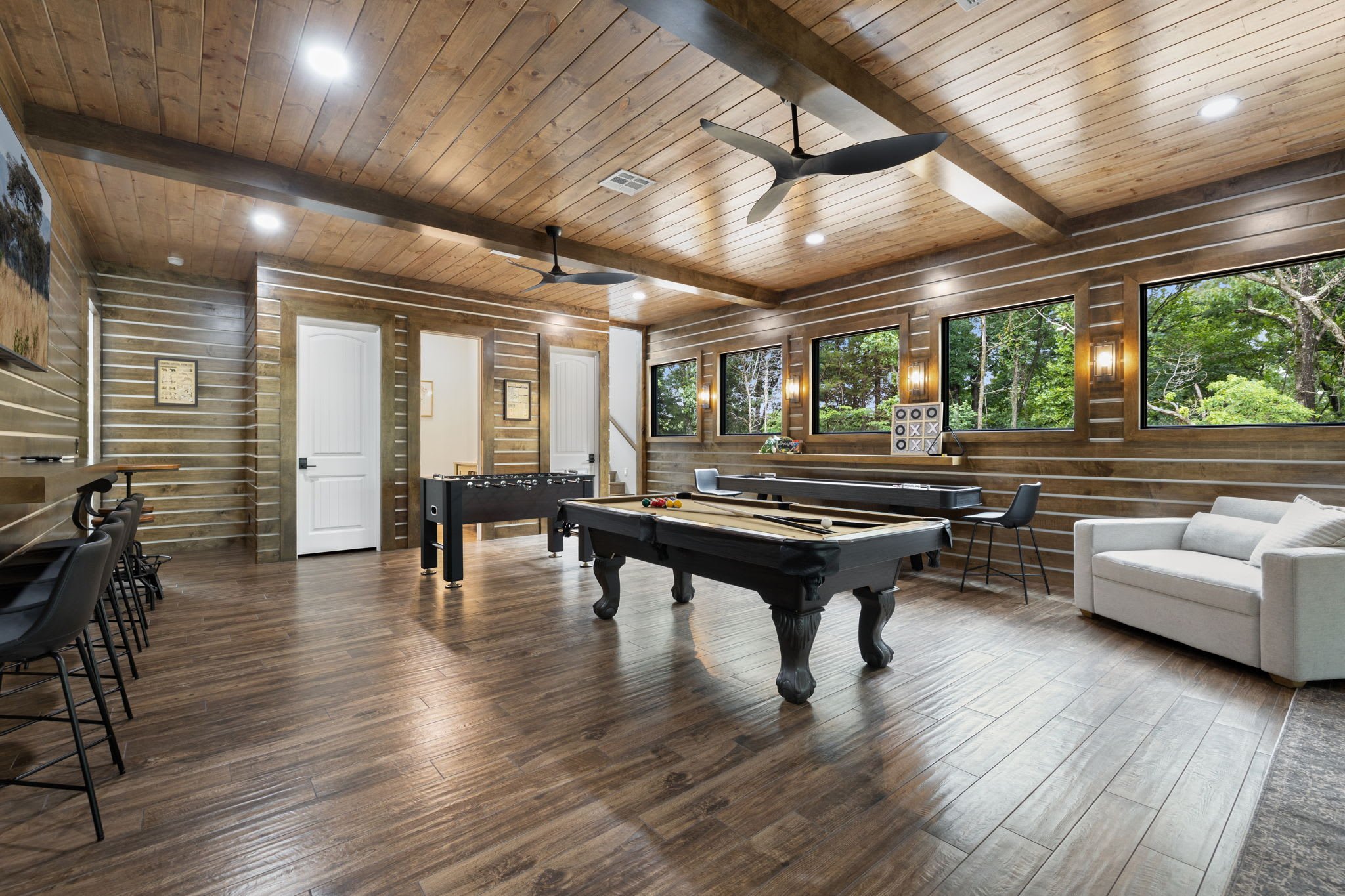 In the game room, you'll find a pool table, shuffleboard table, and a foosball table! This space also has bar seating, and a Smart TV.