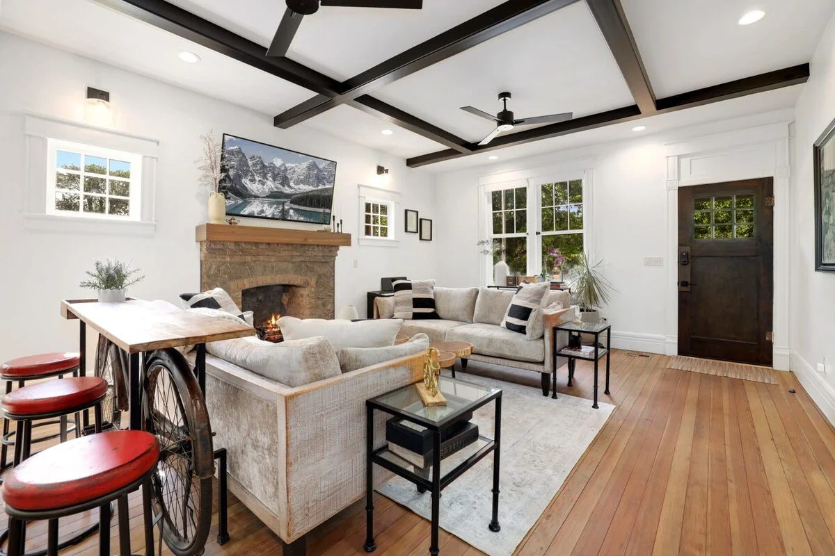  Behind one of the couches, you'll see a bar with stools for added seating. 