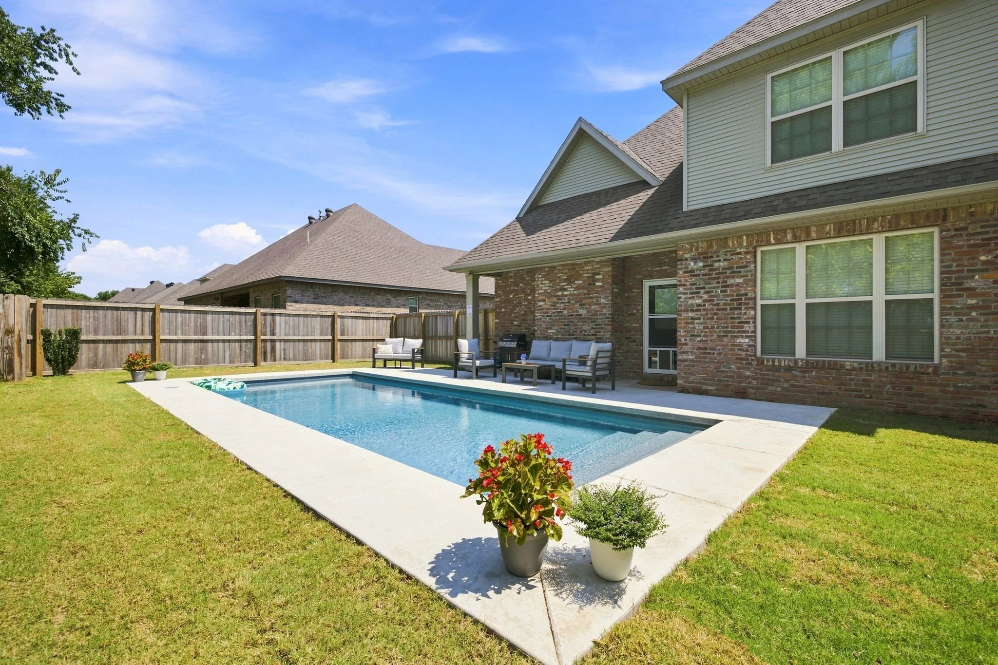 Through the back door in our living room, you'll access our fully furnished outdoor seating area with pool and BBQ grill. Here, you'll also have access to our fenced in backyard, perfect for your crew!
