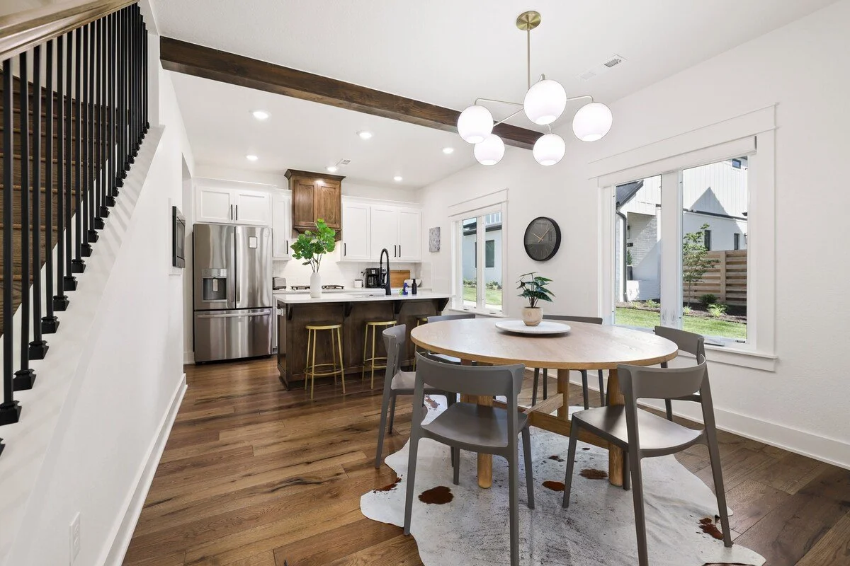 In between the living room and kitchen area, you'll see our round, 6-top dining table - the perfect place to enjoy a meal or play a game of cards with the crew.