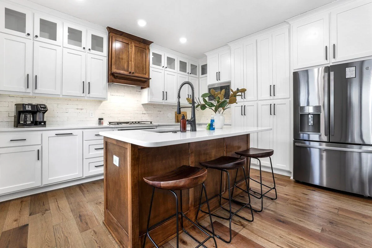 Past the dining area, you'll see our kitchen, which is fully stocked with ample amenities - everything needed to cook or bake your favorite dishes - and brand-new appliances, including a gas stove, combination single serve / drip coffee pot and plent