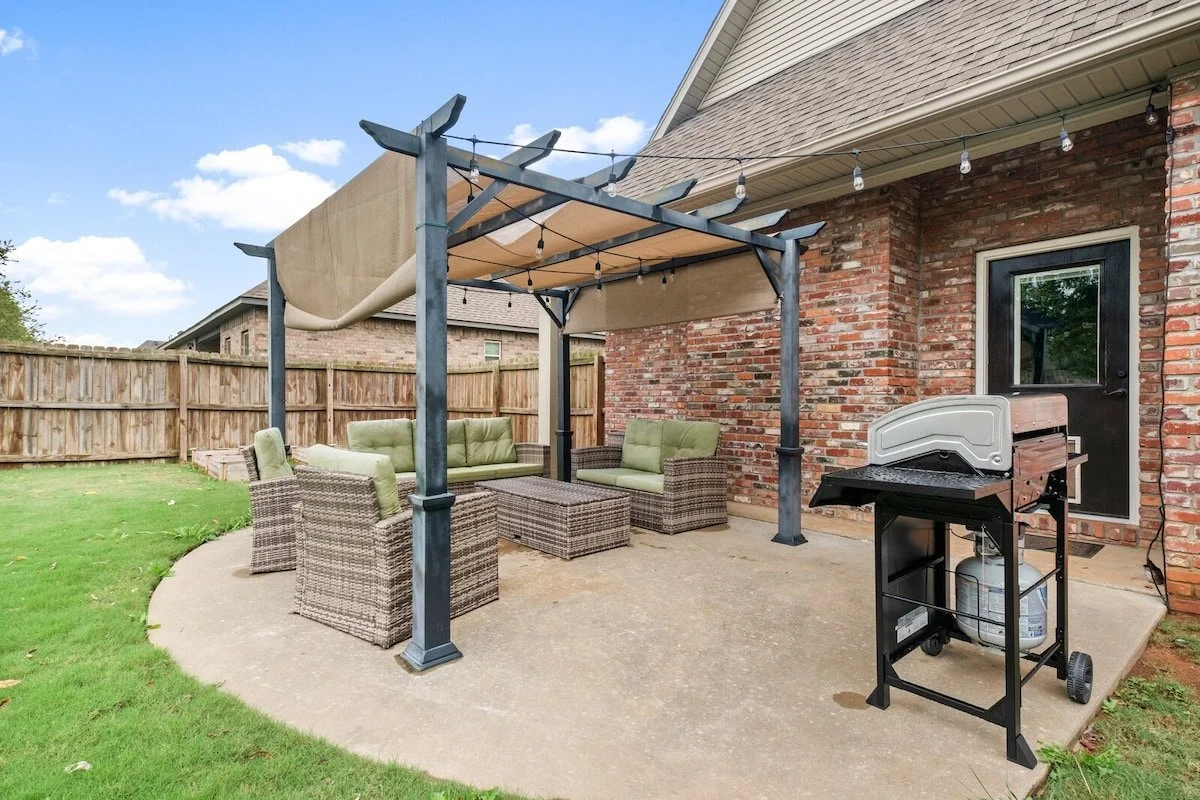 Through the back door in our living room, you'll access our fully furnished outdoor seating area with BBQ grill. Here, you'll also have access to our fenced in backyard with a play swing set - perfect for the kiddos!