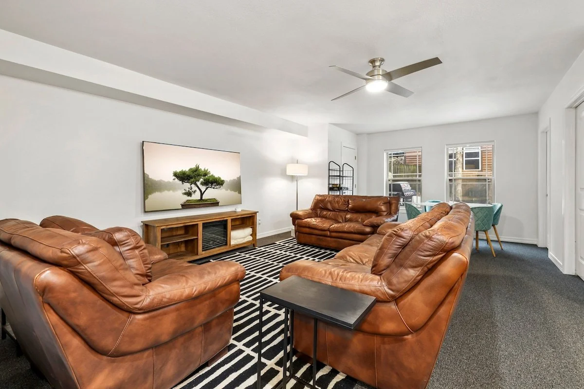In our basement, you’ll have access to our bonus room and third living space. Here, you'll find a couch, loveseat, lounge chair, 4-top dining table, wet bar, foosball table and 75-inch Samsung Smart TV.