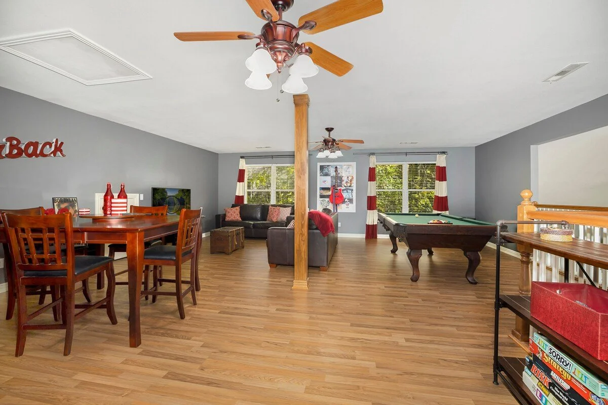 In our upstairs loft space above the main floor, we have a decked-out game room featuring a pool table, board games, a seating area with two leather couches, a Smart TV, another 4-top dining table and a bathroom.