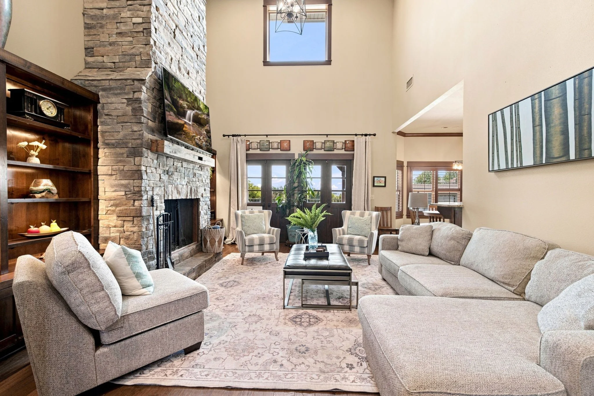 Our main living room is complete with comfy seating, a large Smart TV, and high ceilings. 