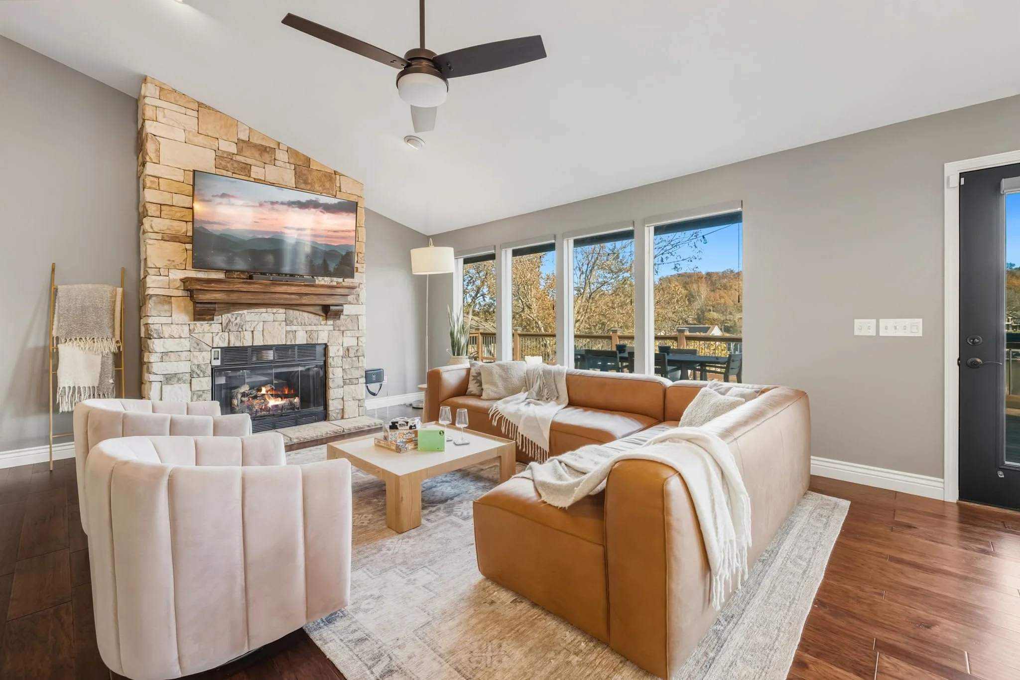 When you first enter our home, you'll be greeted by the large windows with a view and our cozy living room with seating, a Smart TV, and a fireplace.