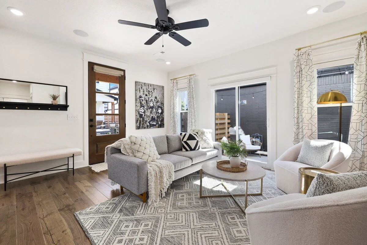 When you walk through the front door, you'll immediately enter into our open concept living room. This has to be our favorite spot in the house because it's flooded with TONS of natural light and accented with bright, modern decor. 