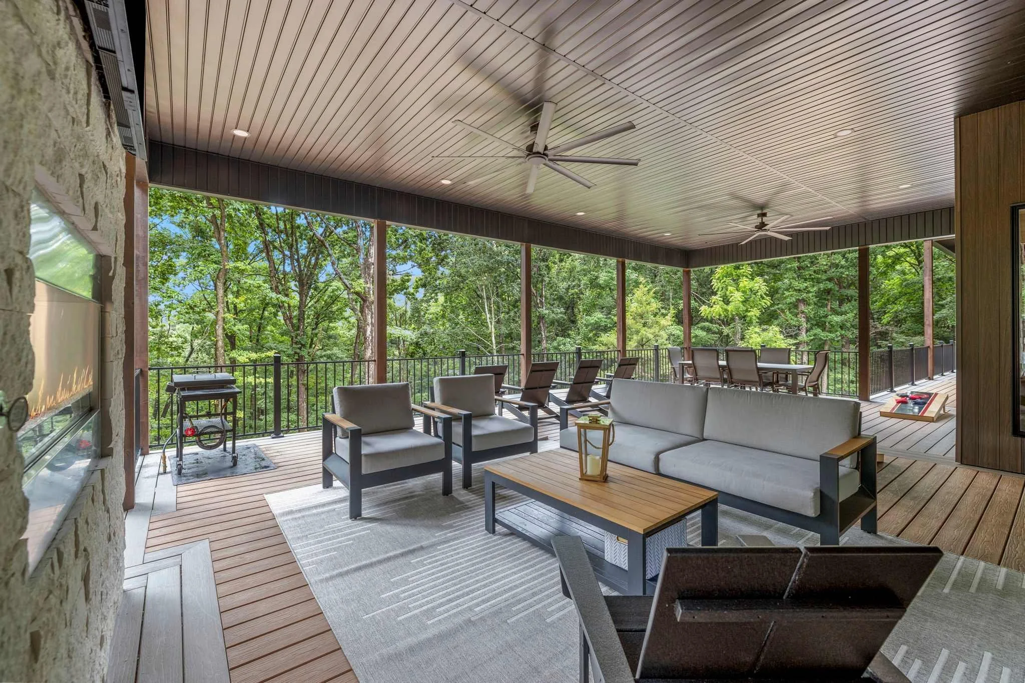 On the other side of the see-through fireplace, our Outdoor Oasis continues. Kick back on the outdoor couch. Watch a movie or your favorite game on yet another Smart TV. — Oh, did we mention the views are stunning from every angle.