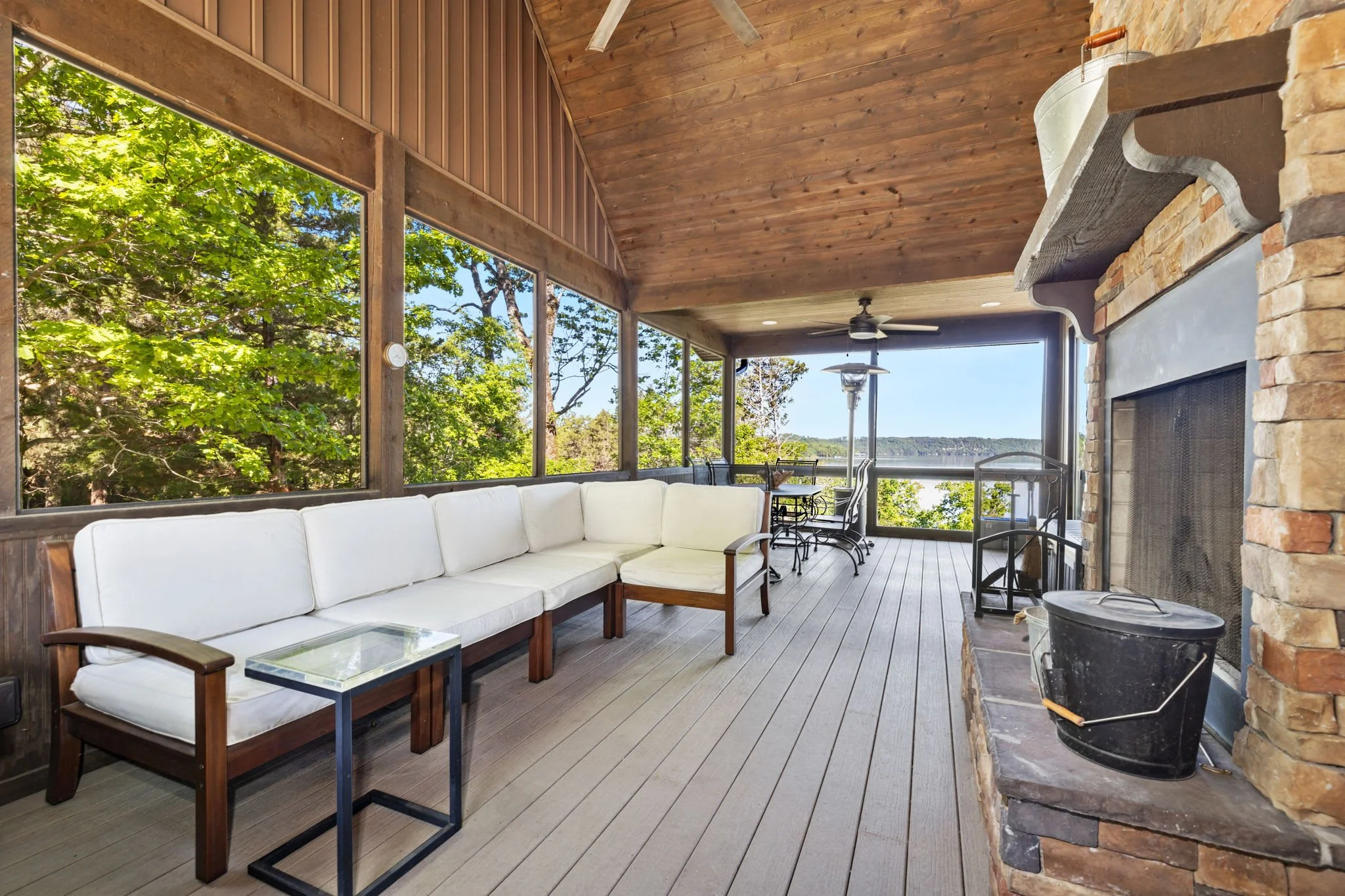 In our large screened-in patio, you will find seating, a dining table, another fireplace, and a Smart TV.