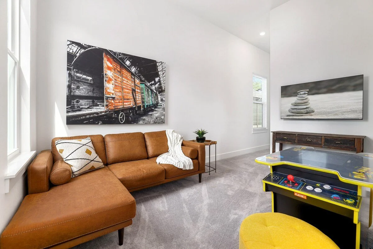 Upstairs, your crew can hang out in a secondary living area, which is complete with a leather couch, our Mr. Pac Man 2 player machine and a 50-inch Hisense Roku TV.  