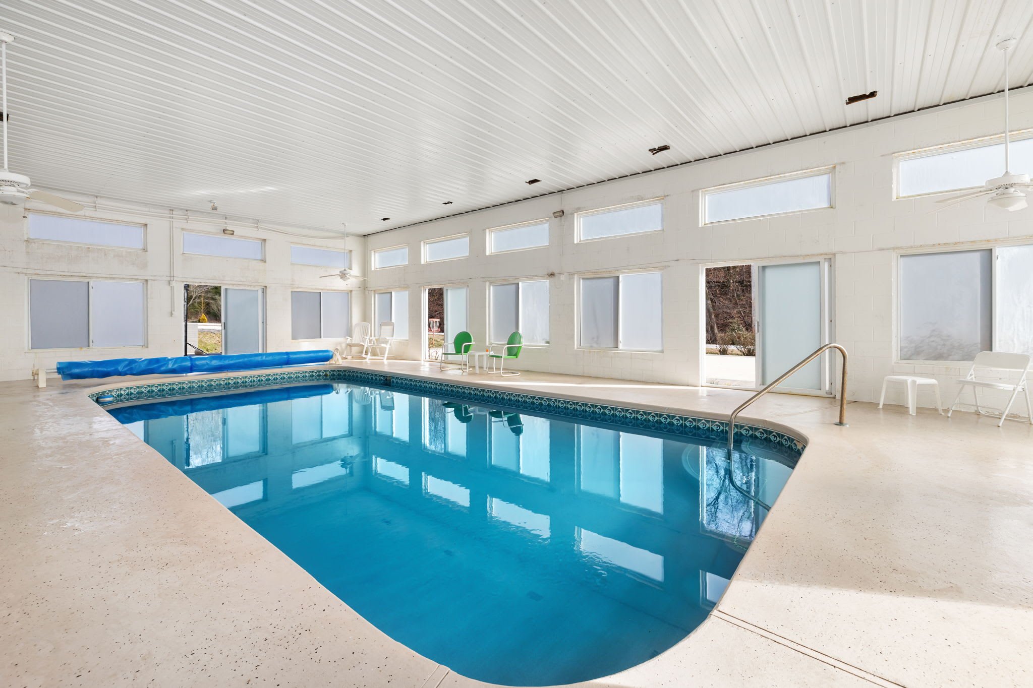Large indoor pool with sliding glass doors 
