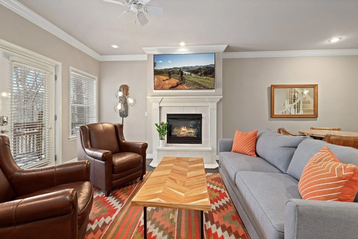 For the times when you can't agree on what to watch, our second living room downstairs features a sofa + two seats centered around a fireplace and an additional 70-inch Smart TV.  