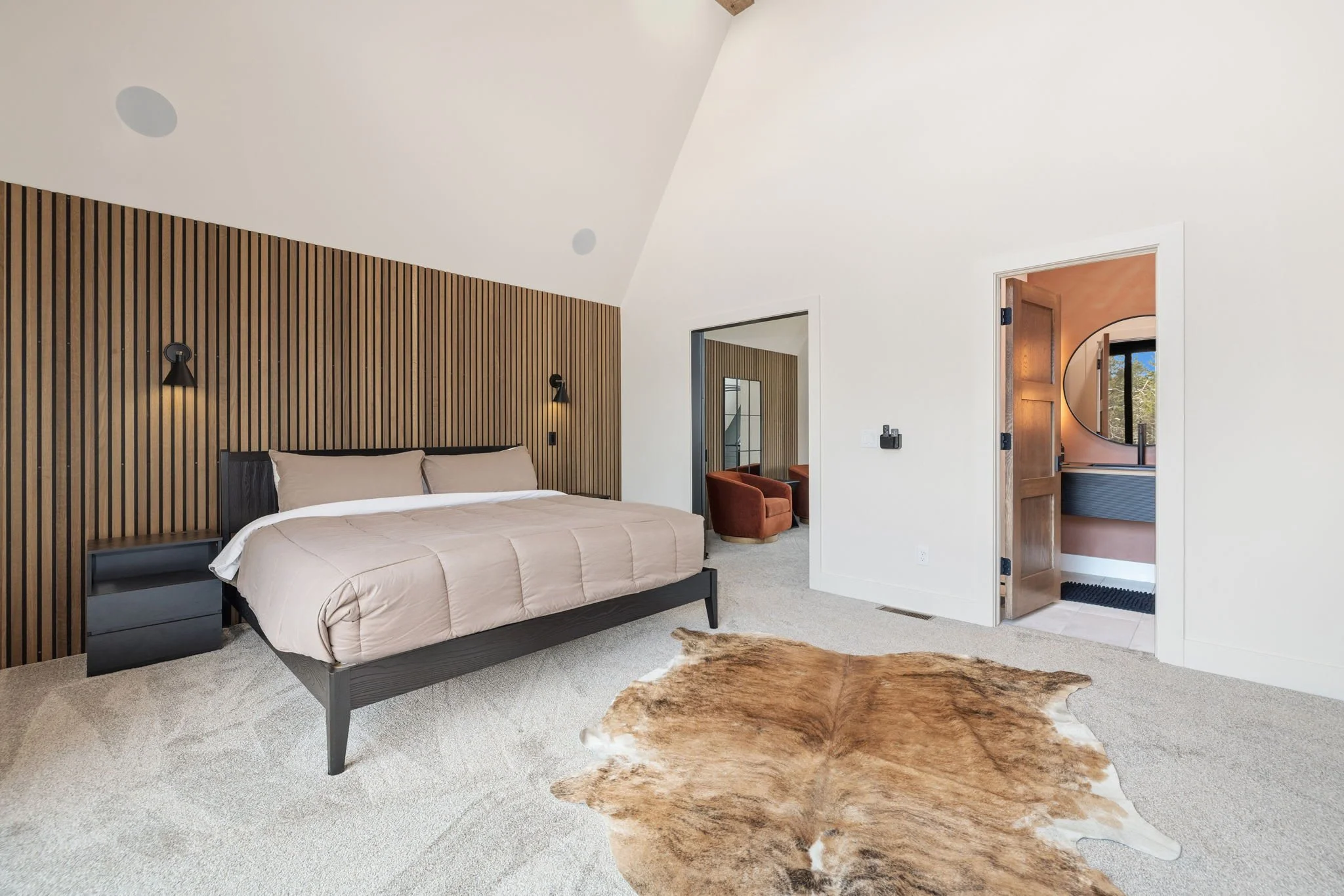 Our primary bedroom - it is complete with a King-size bed, Smart TV, and a luxurious en suite. — In total, AFrame at Beaver Lake sleeps 12 guests.