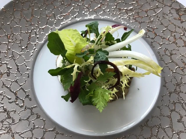 Mushroom appetizer capped with greens