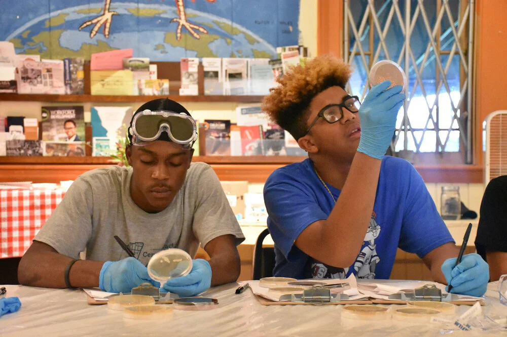  Kai Griffin, left, and Angelo Domingo, right, review samples of water collected from the Hudson River tested for anti-biotic resistance in Troy, N.Y. on July 27, 2018. 