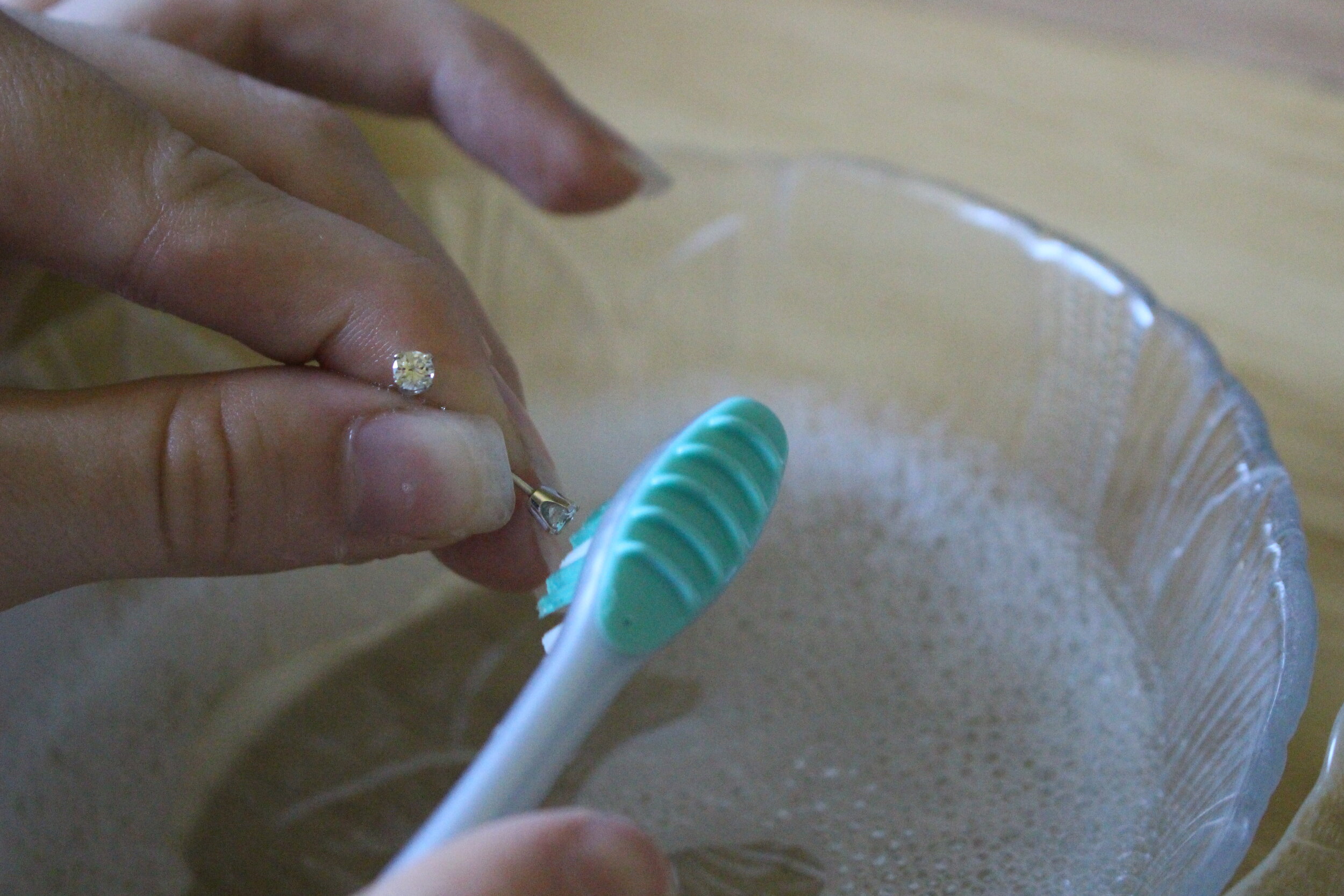  Very gently use a few of the bristles to make sure there is nothing on the underside of the stones.  