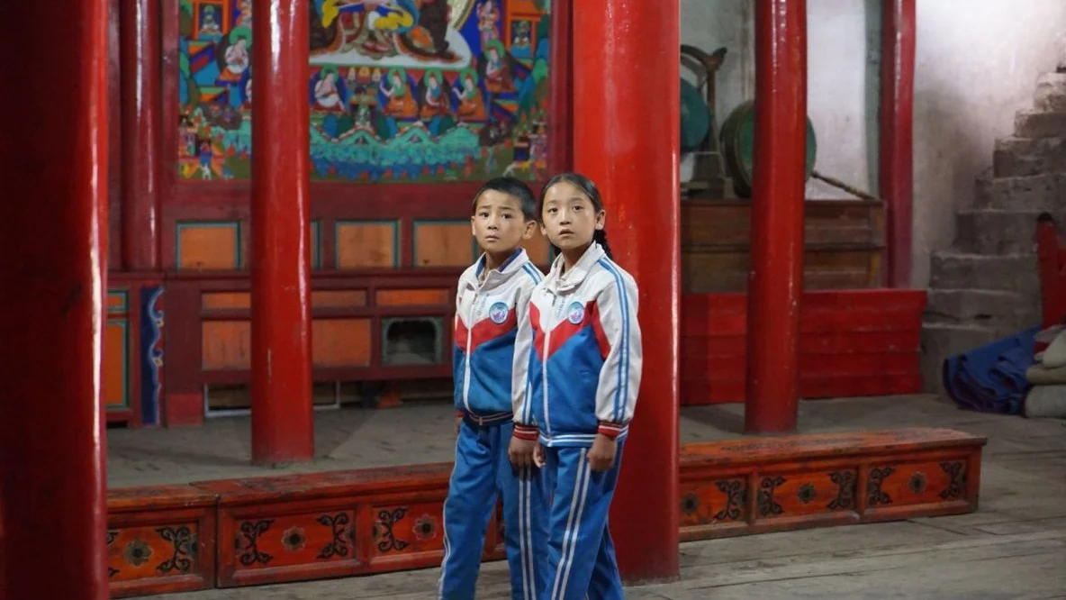 Wangdrak's Rainboots Lhapa Gyal | 2018 | Tibet | Drama | 90' | Tibetan with English Subtitles Screenplay: Lhapa Gyal Actors: Shanma Jyi, Pakmo Yangdrom, Druklha Dorje, and others. Trailer It's the rainy season in the mountains of Tibet. Good for the grain, bad for the little Wangdrak. He is the only pupil of the village school who has no rubber boots and regularly runs the risk of getting his feet wet on the way to school. To make matters worse, he is exposed to the ridicule of the other children. He therefore desires nothing more than to have a pair of rubber boots. But his father has no money to buy him some, and other worries plague him anyway. The silent stubbornness with which Wangdrak pursues his goal determines the further course of the story. Based on a novel by Tserang Dondrup, the film pays loving attention to the boy's condition and tells the story from his point of view. The film tells in a calm and aesthetic visual language a timeless story from rural Tibet, in which people are embedded in their traditions and in which modern civilization has left hardly any traces. Wangdrak's Rain Boots is Lhapal Gyal's first feature film and premiered at the Berlinale 2018.