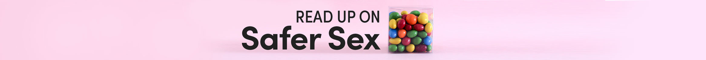 Text reading 'Read up on Safer Sex' in front a pink background with a clear jar of candy