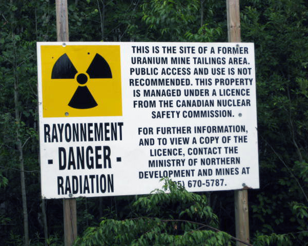 MNDM radiation warning on uranium mine tailings area.