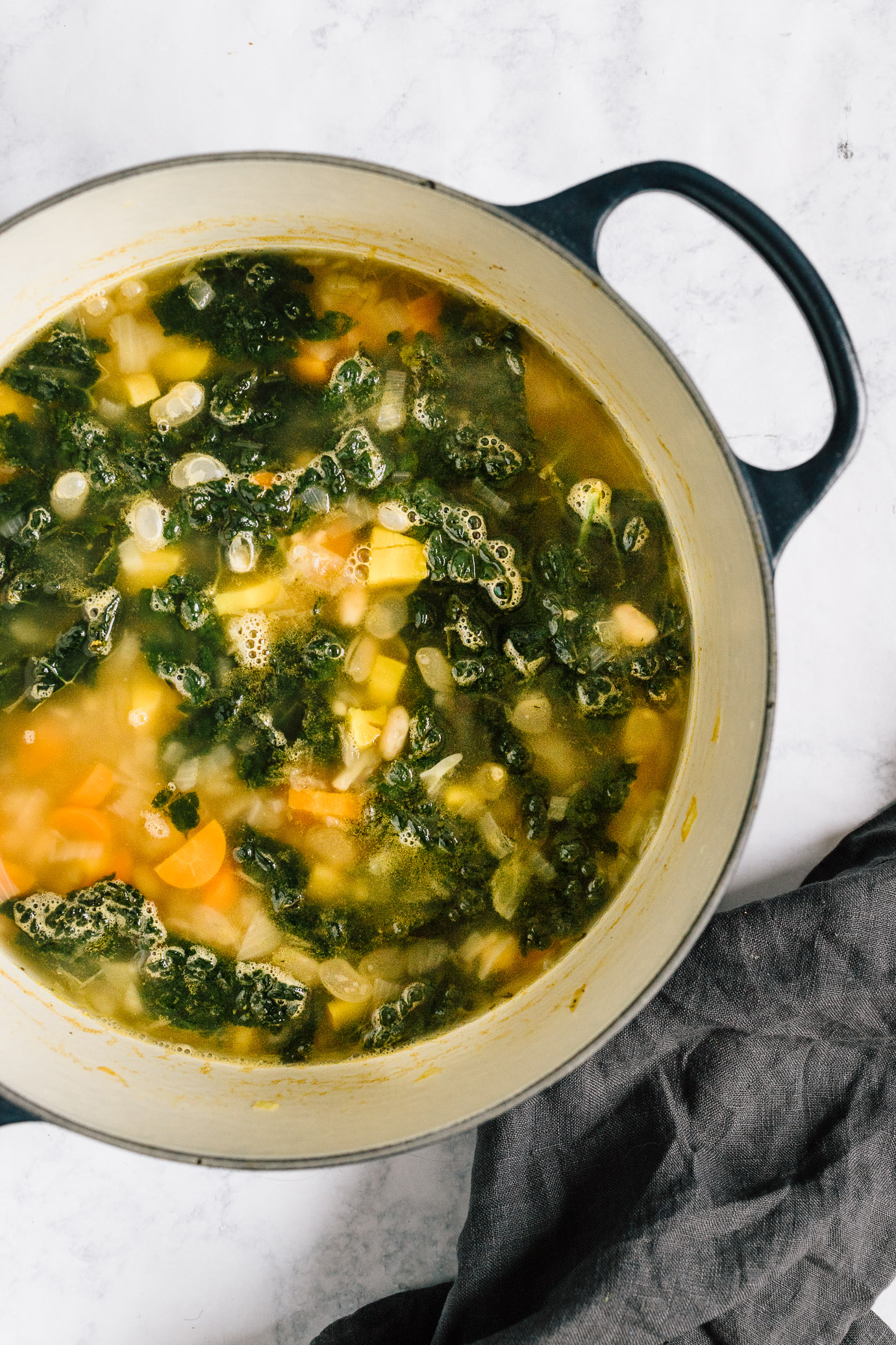 kale and white bean soup with lemon in Le Cruset